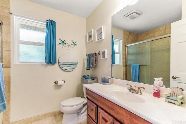 bathroom with tile patterned flooring, vanity, an enclosed shower, and toilet