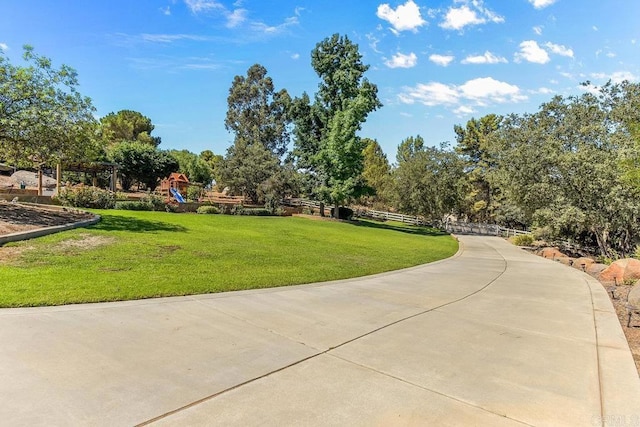 view of property's community featuring a yard