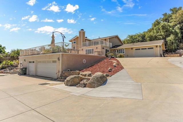 view of front of property featuring a balcony and a garage