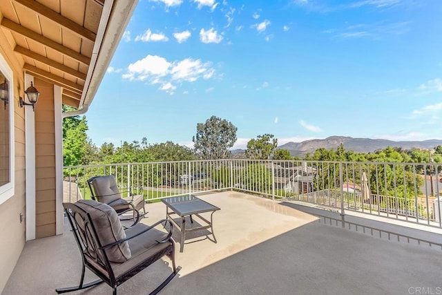 view of patio / terrace featuring a mountain view and a balcony