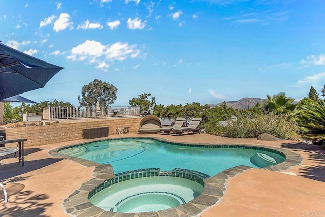 view of swimming pool with an in ground hot tub and a patio