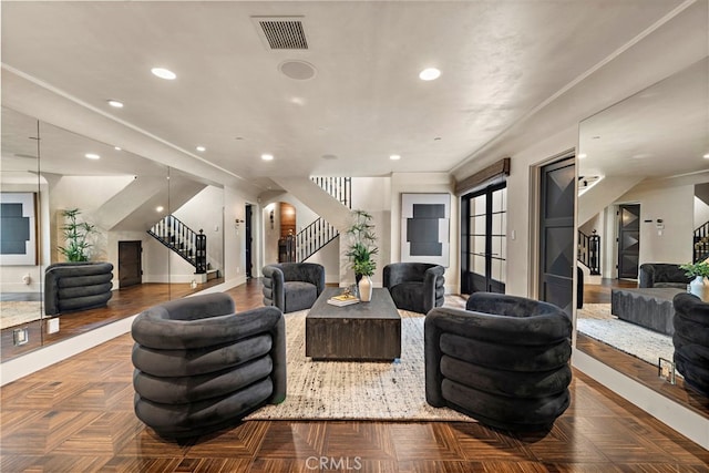 living room with crown molding and parquet flooring