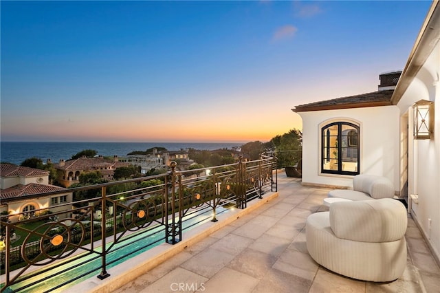 balcony at dusk with a water view