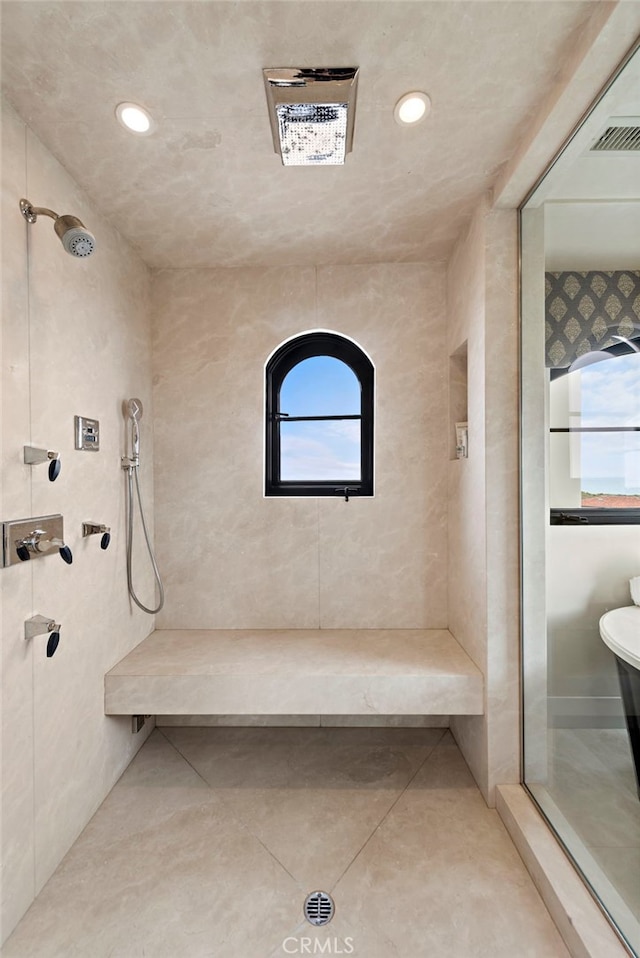 bathroom featuring tile patterned floors and tiled shower