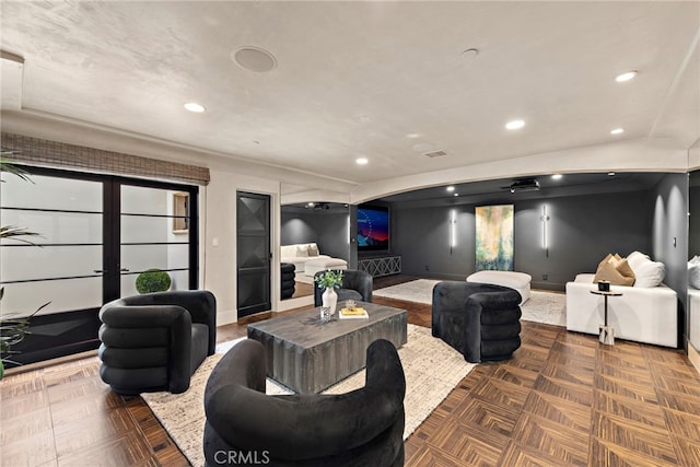 living room featuring vaulted ceiling, dark parquet flooring, and french doors