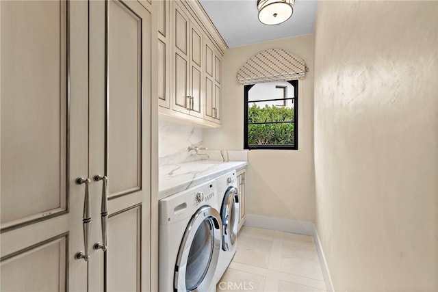 washroom featuring light tile patterned flooring, cabinets, and separate washer and dryer