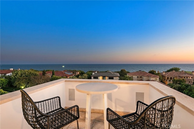 exterior space featuring a water view and a balcony