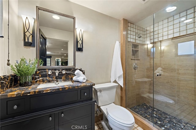 bathroom with vanity, toilet, and a shower with shower door