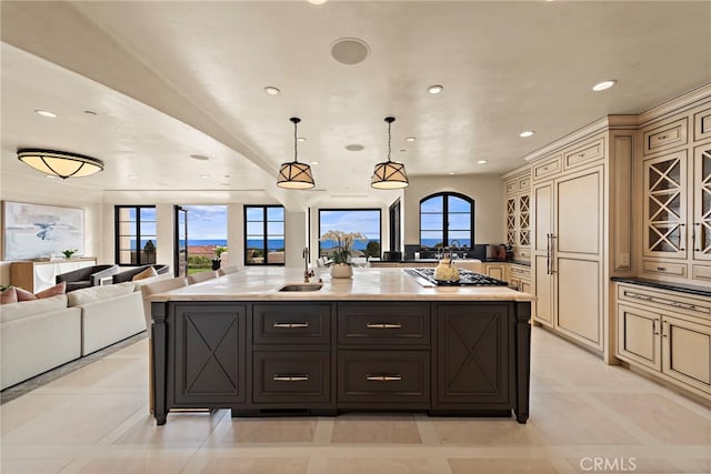 kitchen featuring a spacious island, hanging light fixtures, cream cabinetry, and stainless steel gas stovetop