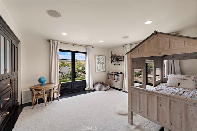 carpeted bedroom with french doors and access to outside