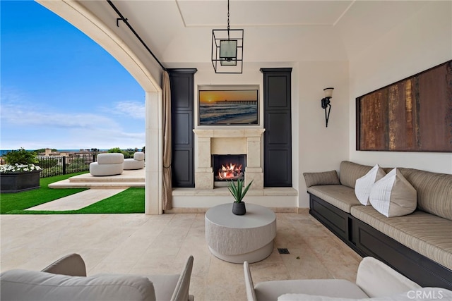 view of patio featuring an outdoor living space with a fireplace