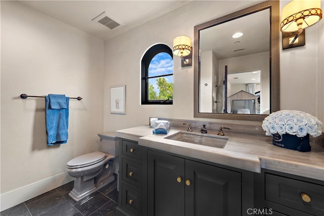 bathroom with vanity and toilet