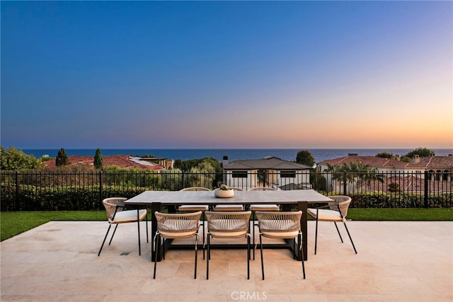 patio terrace at dusk with a water view