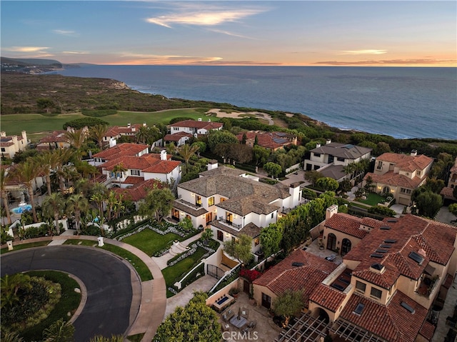 aerial view at dusk with a water view