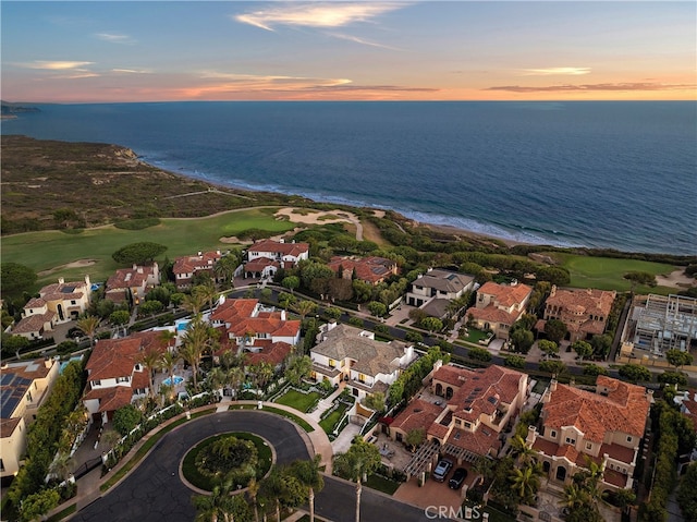 aerial view at dusk with a water view