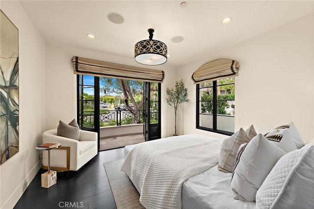 bedroom with dark hardwood / wood-style floors