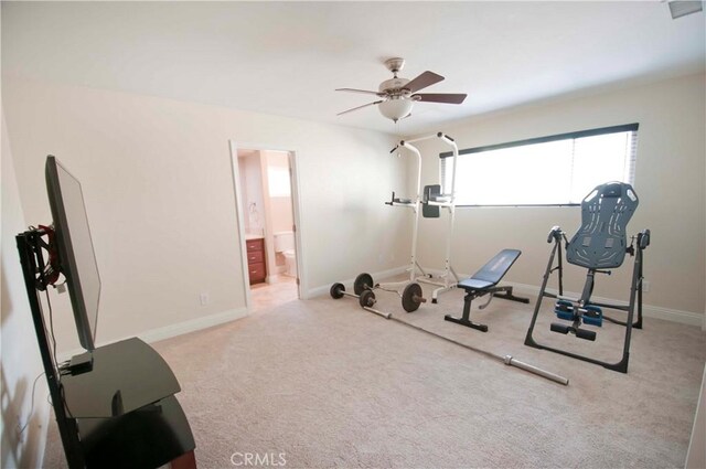 workout room with ceiling fan and light carpet