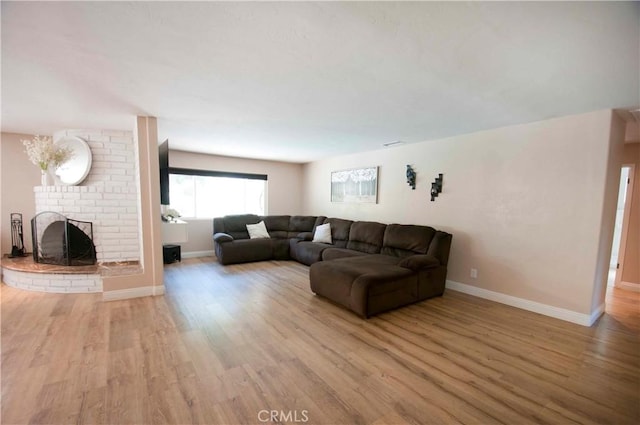 living room with a fireplace and light hardwood / wood-style flooring