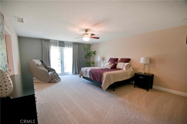 bedroom featuring ceiling fan, access to exterior, light carpet, and french doors