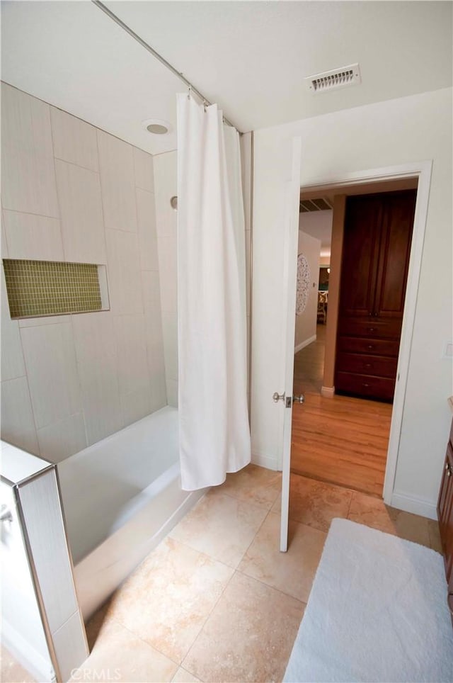 bathroom with shower / tub combo, vanity, and hardwood / wood-style floors