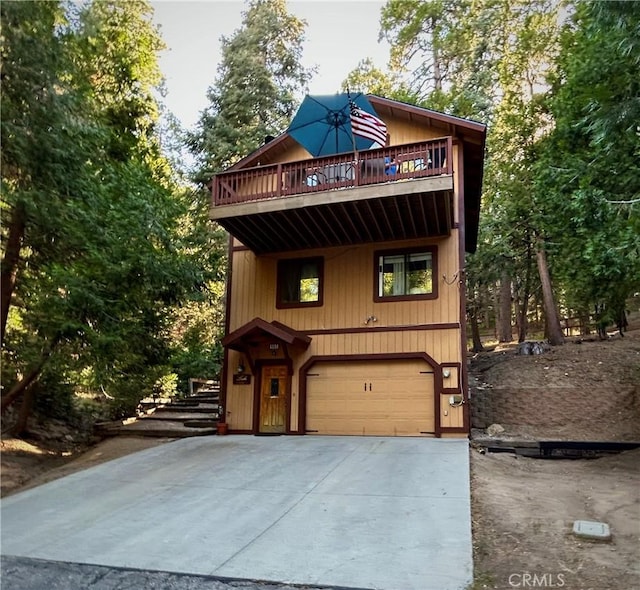 view of property featuring a balcony and a garage