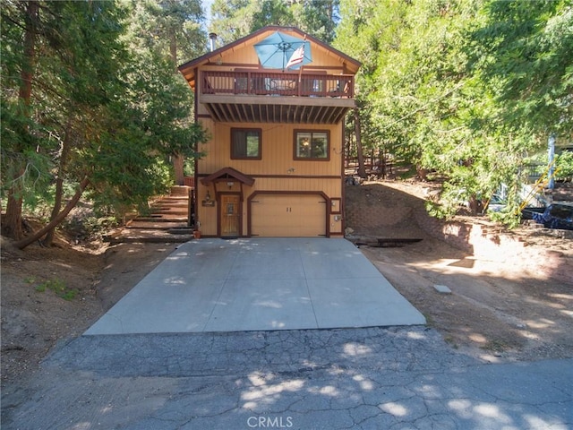 front facade featuring a balcony and a garage