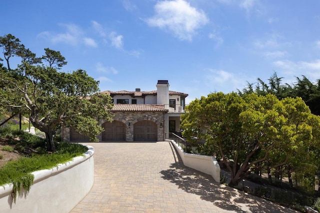 mediterranean / spanish-style house with a garage