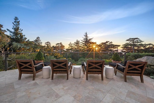 patio terrace at dusk featuring outdoor lounge area