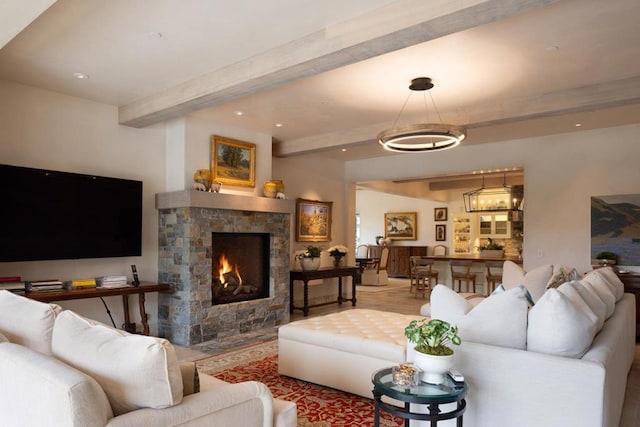 living room featuring beam ceiling and a fireplace