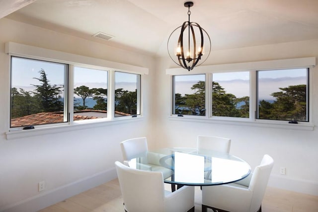 dining area featuring a notable chandelier and light hardwood / wood-style floors