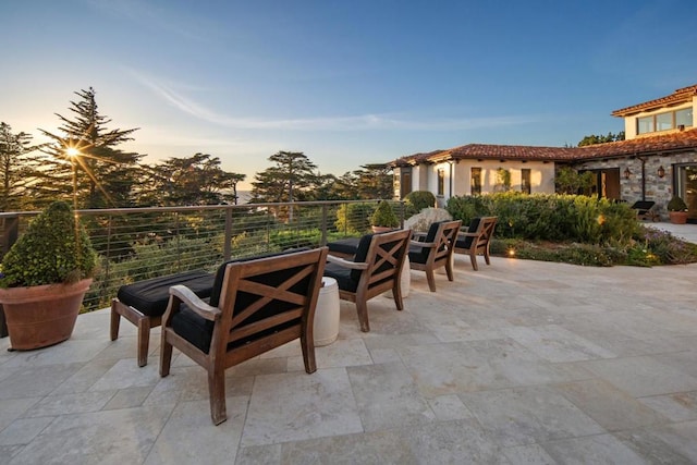 view of patio terrace at dusk