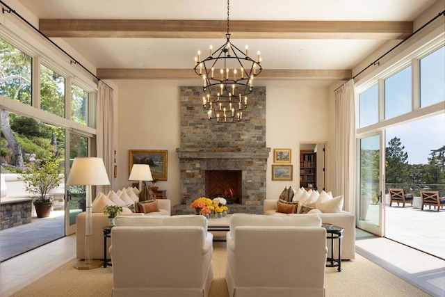 living room featuring a notable chandelier, beamed ceiling, and a fireplace