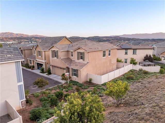 exterior space with a garage and a mountain view