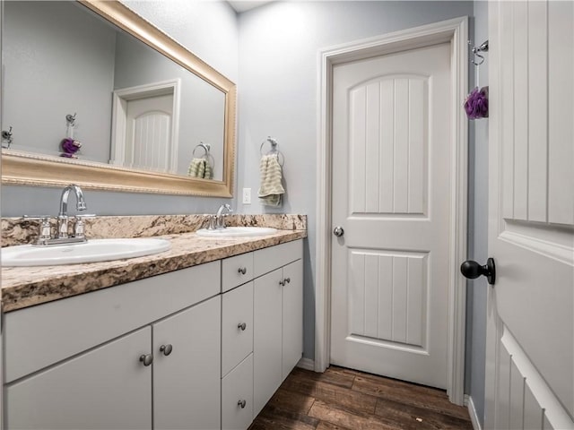 bathroom with wood-type flooring and vanity