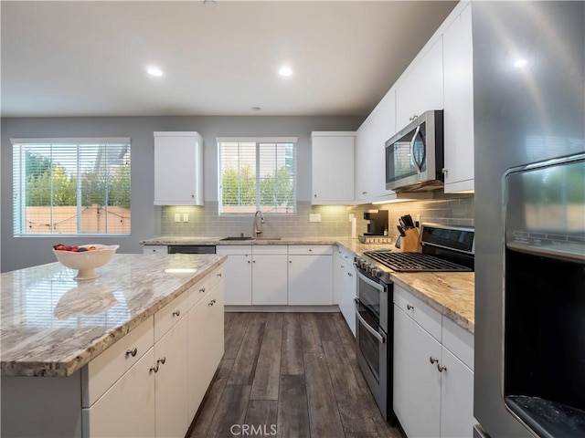 kitchen featuring sink, white cabinetry, dark hardwood / wood-style flooring, and stainless steel appliances