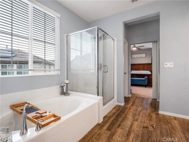 bathroom featuring a shower with shower door, ceiling fan, and hardwood / wood-style flooring