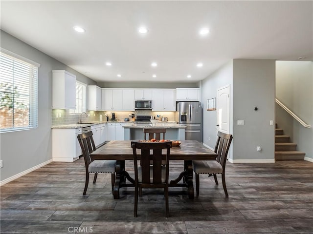 dining area with dark hardwood / wood-style floors and sink