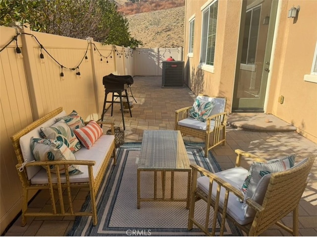 view of patio with outdoor lounge area and central AC