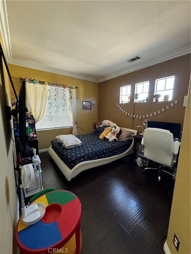 bedroom featuring a textured ceiling, crown molding, and dark wood-type flooring