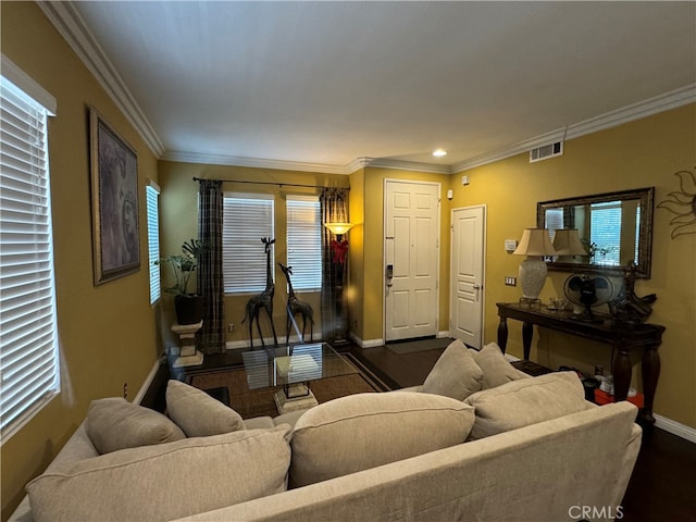 living room featuring dark hardwood / wood-style flooring, plenty of natural light, and crown molding