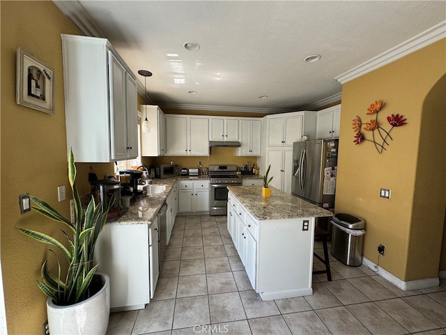 kitchen featuring ornamental molding, a kitchen island, white cabinetry, stainless steel appliances, and light stone countertops