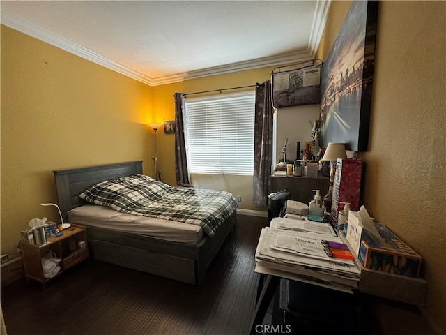 bedroom with crown molding and dark hardwood / wood-style flooring