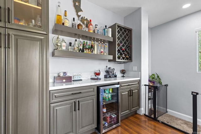 bar with beverage cooler and dark hardwood / wood-style floors