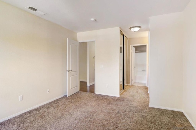 unfurnished bedroom with light colored carpet