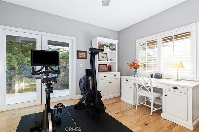 exercise room featuring light wood-type flooring