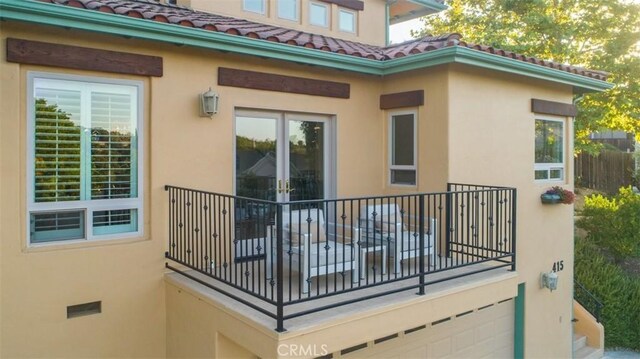 view of home's exterior with a garage and a balcony