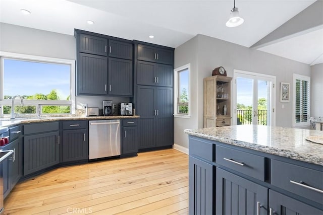 kitchen featuring vaulted ceiling, dishwasher, sink, hanging light fixtures, and light hardwood / wood-style flooring