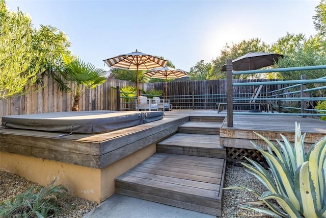 wooden terrace with a covered hot tub