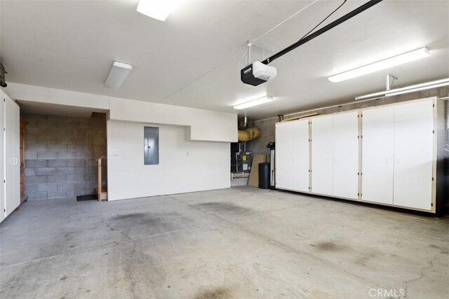 garage with a garage door opener and electric panel