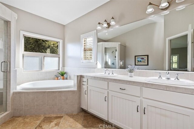 bathroom featuring vanity and plus walk in shower